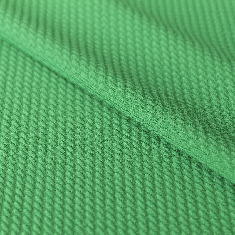 Geometrischer grüner Jacquard-Strickstoff - Ribes y Casals